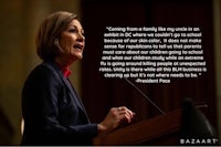 a woman giving a speech at a podium with a quote