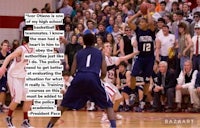 a basketball player is going to the basket in front of a crowd