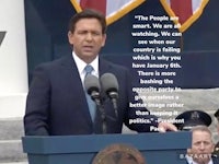 a man in a suit and tie is giving a speech