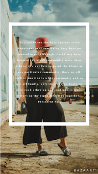 a woman wearing a red hat and a black jumpsuit standing in front of a brick wall